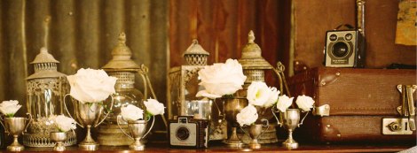 Mixture of lanterns, votives, baby trophies, vintage cameras which added vintage flair