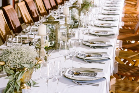 Long banquet tables with lanterns, candlesticks and votives